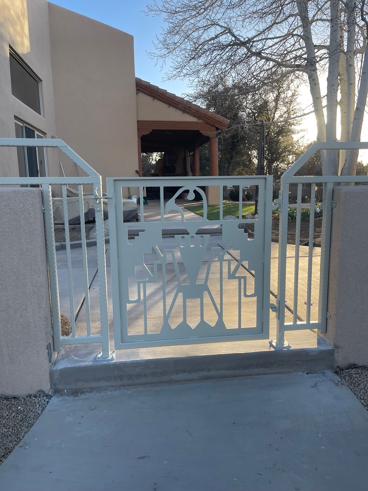 Custom entry gate with thunderbird cutout panel and matching side railing