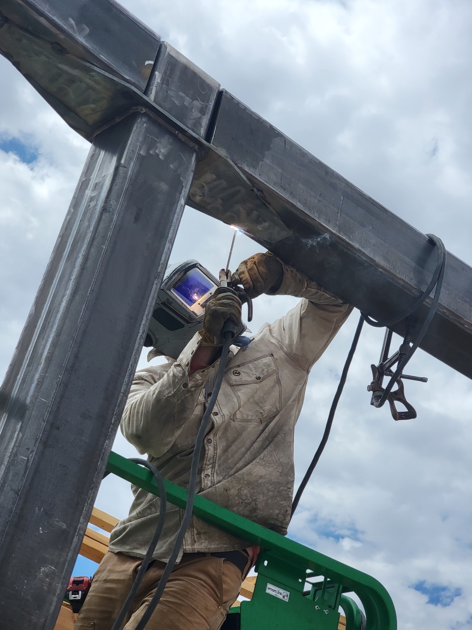 Welder running a certified structural weld on a moment frame connection