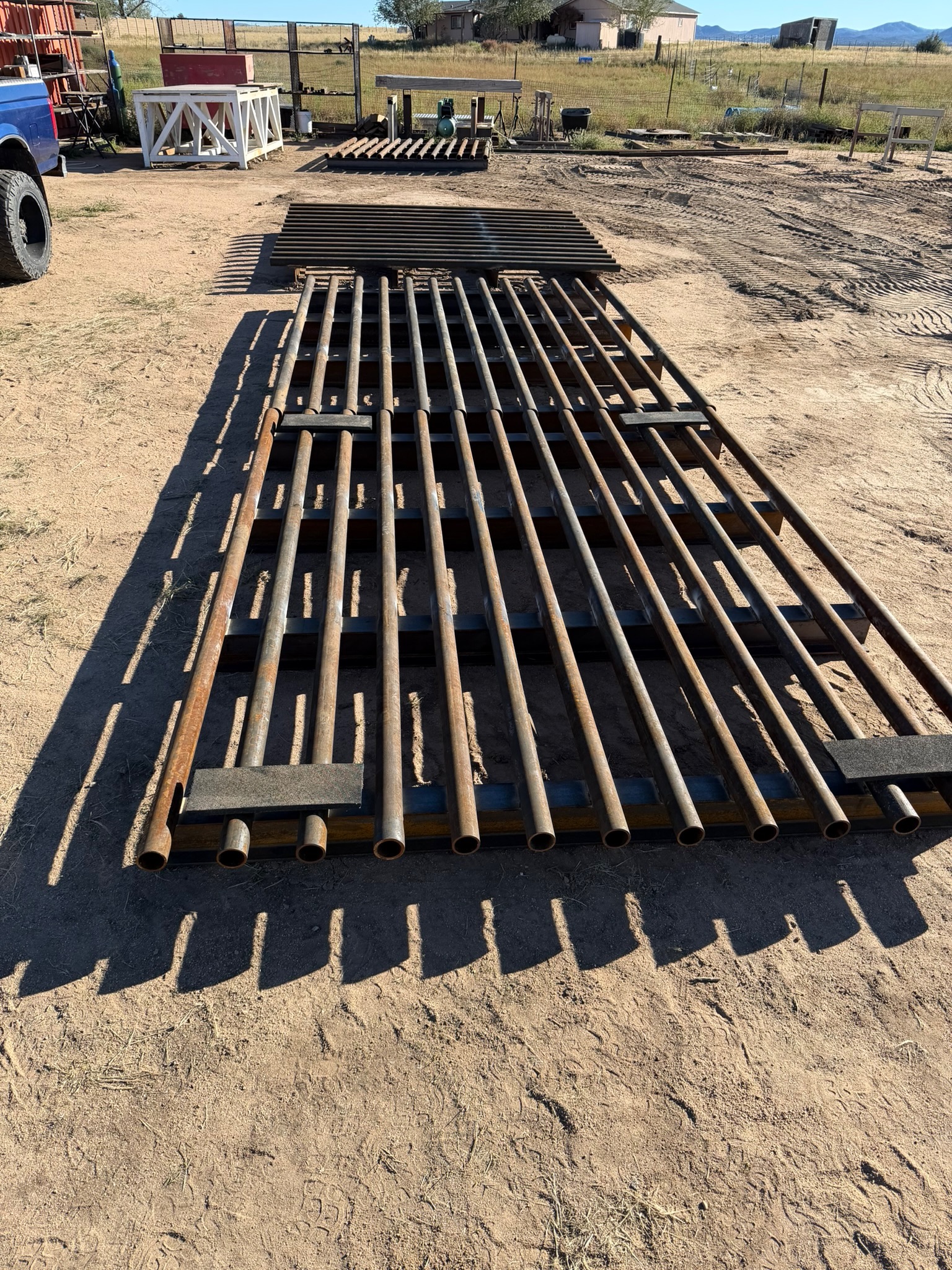 Batch run of fabricated cattle guards laid out in the shop yard